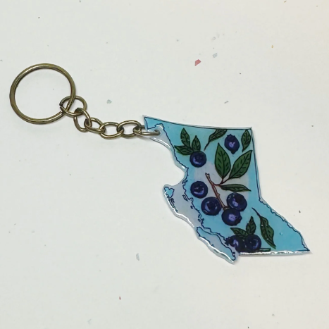 Keychain shaped like the state of British Columbia with floral design on a white background