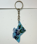 Keychain shaped like a stylized map of British Columbia with floral design on a white background