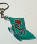 Keychain with a design of British Columbia and a jellyfish on a plain background