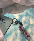 Keychain with cartoon characters on a cloud-patterned background