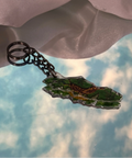Keychain with a map design on a cloudy sky background