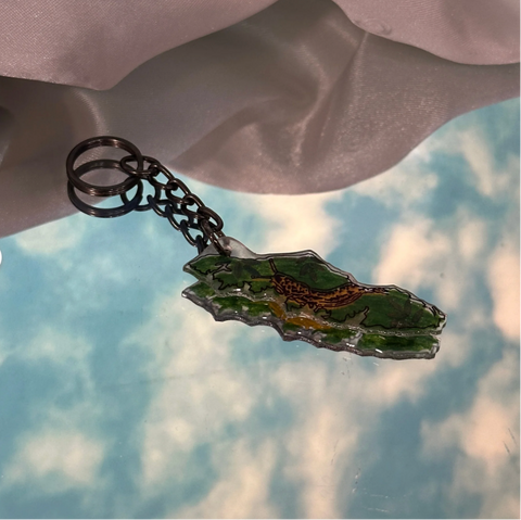 Keychain with a map design on a cloudy sky background
