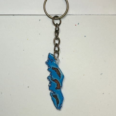 Keychain with a blue and brown design on a light gray background