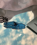 Close-up of a blue ring on a reflective surface with a blurred background