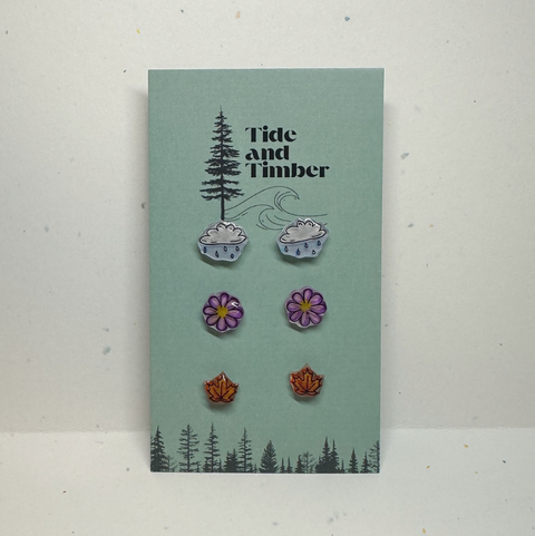 Earring set on a 'Tide and Timber' branded card with nature-themed design.