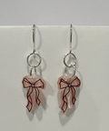 Earrings with bow designs on a light gray background
