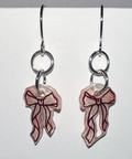 Pair of earrings with bow design on a light gray background