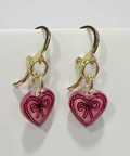 Heart-shaped earrings with pink hearts and gold accents on a white background