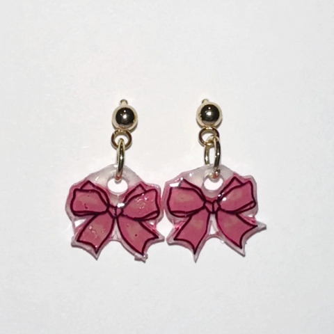 Pair of earrings with pink bow designs on a white background