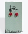Red earrings on a Tide and Timber branded card with a white background