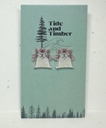 Card with cat earrings illustration and 'Tide and Timber' branding on a light green background.