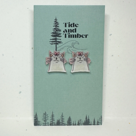 Card with cat earrings illustration and 'Tide and Timber' branding on a light green background.