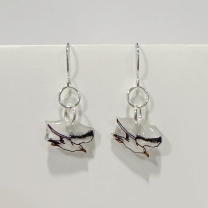 Pair of silver earrings with marbled design on a white background