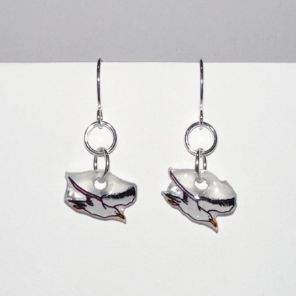 Silver earring with a small round design on a light gray background