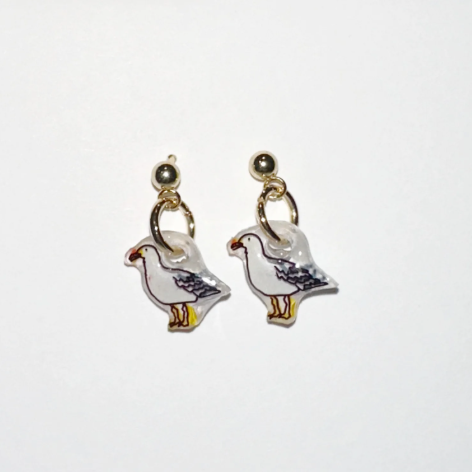 Pair of bird-shaped earrings on a white background