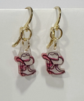 Cowboy boot earrings with gold hooks on a light gray background