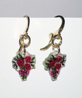 Pair of earrings with floral designs on a white background