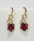 Handmade earrings with strawberry design on a white background
