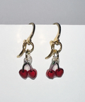 Handmade earrings with cherry design on a gray background