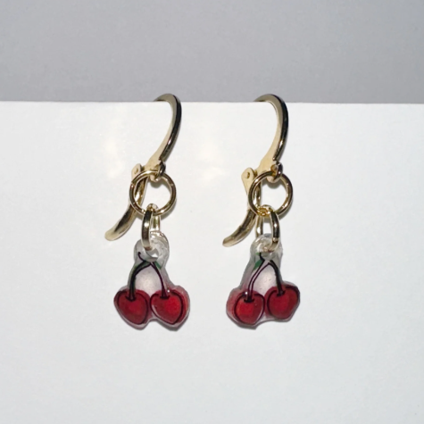 Handmade earrings with cherry design on a gray background