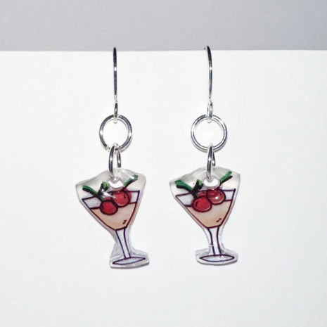 Pair of earrings with glass design and berries on a white background