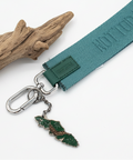 Green keychain with a small green tag on a wooden surface