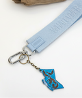 Keychain with blue and brown design on a wooden surface
