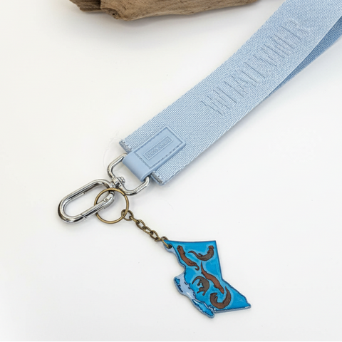 Keychain with blue and brown design on a wooden surface