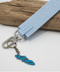 Light blue lanyard with a keychain on a wooden surface