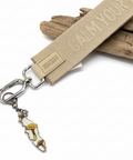Keychain with a humorous message on a wooden surface