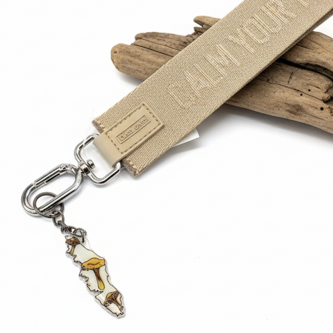 Keychain with a humorous message on a wooden surface
