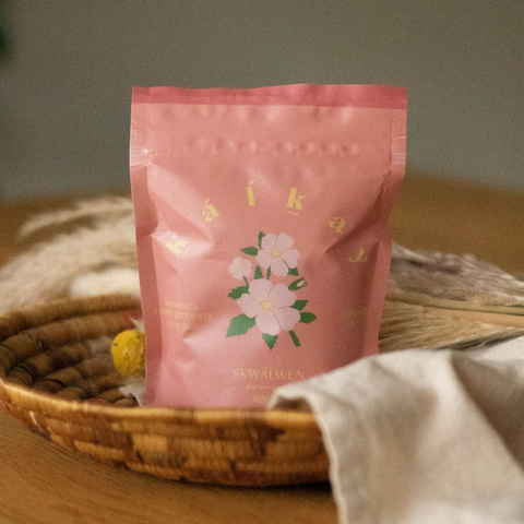 Pink packaging with floral design on a woven basket