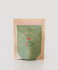 Green and brown package with brand name on a light gray background