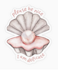 Sticker with a shell and pearl design and text 'please be nice' and 'I am delicate' on a white background.