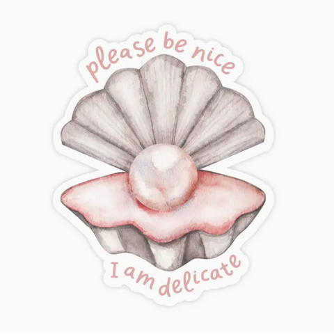 Sticker with a shell and pearl design and text 'please be nice' and 'I am delicate' on a white background.