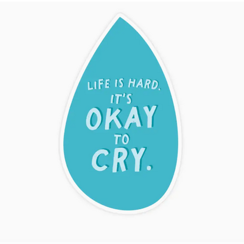 Teal teardrop-shaped sticker with white text 'Life is hard. It's okay to cry.' on a white background