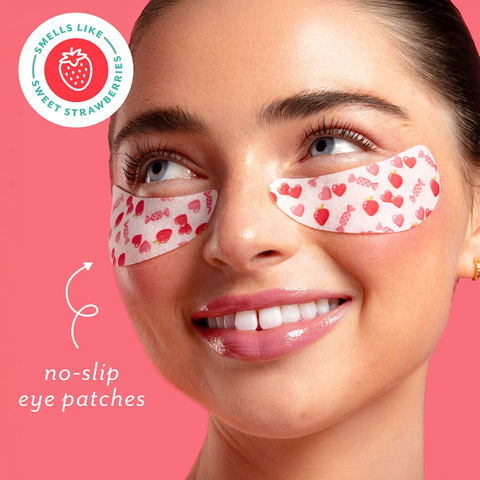 Woman wearing strawberry-themed eye patches with a pink background and branding elements.