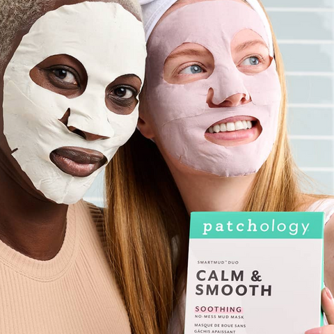 Two women wearing sheet masks with a 'patchology' product box in the foreground.