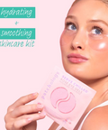 Woman holding a skincare product with text 'hydrating + smoothing skincare kit' on a pink background