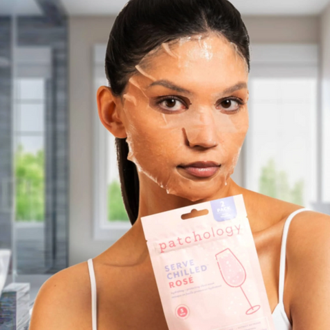 Woman applying a patchology facial mask with a box in the foreground