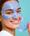 Woman wearing a blue face mask against a teal background