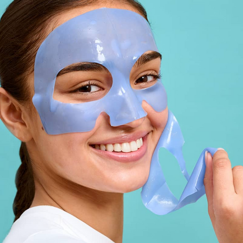 Woman wearing a blue face mask against a teal background