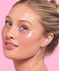 Woman with eye patches on a pink background