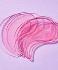 Pink and clear eye masks on a light purple background