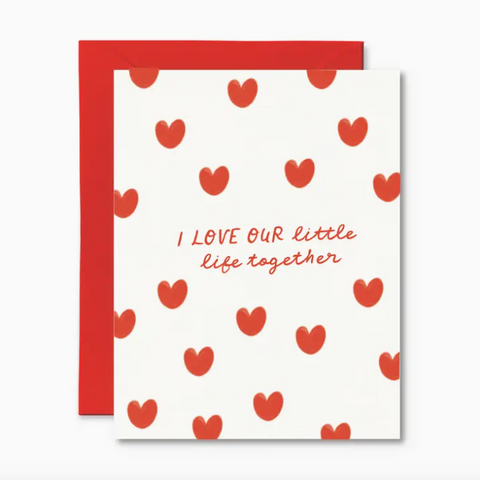 Card with red heart pattern and text 'I LOVE OUR little life together' on a white background