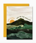 Greeting card with mountain landscape and 'Good things are on the horizon' text, yellow envelope.
