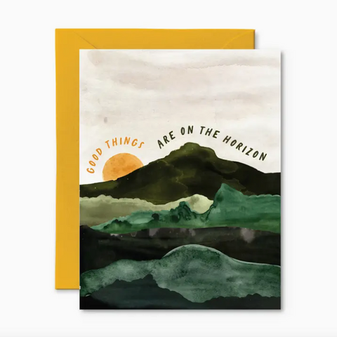 Greeting card with mountain landscape and 'Good things are on the horizon' text, yellow envelope.