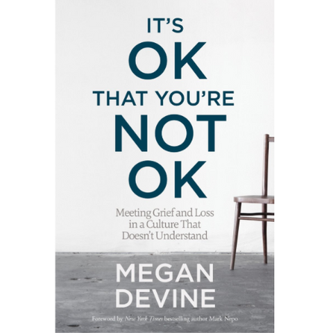 Book cover of 'It's OK That You're Not OK' by Megan Devine with a chair on a gray floor.