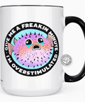 White mug with black handle featuring a colorful puffer fish graphic and text on a white background.