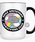 White mug with black handle featuring a cloud and rainbow design on a white background